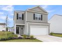 Charming two-story home with a two-car garage, landscaped yard, and grey siding with black shutters at 244 Wild Strawberry Ln, Moncks Corner, SC 29461