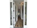 Inviting entryway with stylish front door, wood-look floors, modern lighting, and staircase at 2508 Corona St, North Charleston, SC 29405