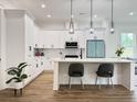 Modern kitchen with white cabinets, quartz countertops, stainless steel appliances, and island seating at 2508 Corona St, North Charleston, SC 29405