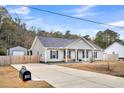 Well-maintained home with a long driveway, storage shed, and fenced yard at 255 S Railroad Ave, Ridgeville, SC 29472