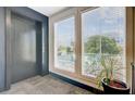 Hallway elevator with a window view and green plant at 259 E Bay St # 7C, Charleston, SC 29401