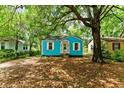 Inviting exterior of a bright blue home with a well-maintained yard and mature trees at 2654 Harvey Ave, North Charleston, SC 29405