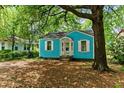 Charming blue home with white trim, shuttered windows, and a tree-lined front yard at 2654 Harvey Ave, North Charleston, SC 29405