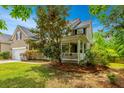 A beautiful two story home sits surrounded by lush landscaping and mature trees at 3025 Buckeley Cir, Charleston, SC 29414