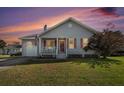 Charming single-story home featuring a cozy front porch, attached garage, and well-maintained lawn at 3050 Brigham Ct, North Charleston, SC 29406
