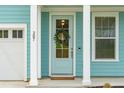 Charming front door with a wreath, sidelight and house number 307 at 307 Theus Pl, Huger, SC 29450