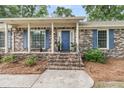 Close-up view of the brick front porch with blue door and white columns at 31 Monte Sano Dr, Hanahan, SC 29410