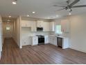 Bright kitchen features stainless appliances, white cabinetry, and hardwood flooring at 3214 Pinewood Dr, Ladson, SC 29456