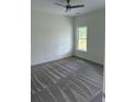 Cozy bedroom featuring neutral carpeting, white trim, and a large window offering natural light at 3222 Pinewood Dr, Ladson, SC 29456