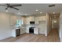 Bright kitchen features stainless appliances, white cabinetry, quartz countertops, and modern lighting at 3222 Pinewood Dr, Ladson, SC 29456