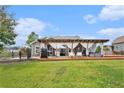 Expansive backyard patio with outdoor seating, grill, and lush lawn perfect for entertaining guests at 3319 Dunwick Dr, Johns Island, SC 29455