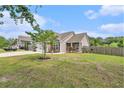 Inviting home exterior featuring a well-maintained lawn, fresh landscaping, and a spacious driveway at 3319 Dunwick Dr, Johns Island, SC 29455