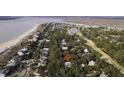 Stunning aerial view showcasing the property's location nestled among lush trees near the coast at 3320 Myrtle St, Edisto Island, SC 29438