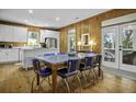 Inviting dining area featuring wood walls, and a view to the kitchen, creating a warm and social atmosphere at 3320 Myrtle St, Edisto Island, SC 29438
