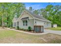 Home exterior featuring attached garage, manicured landscaping, and walkway at 3360 Fickling Hill Rd, Johns Island, SC 29455