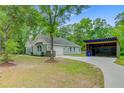 Home exterior showcasing attached garage, long driveway, and covered parking at 3360 Fickling Hill Rd, Johns Island, SC 29455
