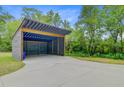 Open-air parking structure with concrete pad and partial privacy screen at 3360 Fickling Hill Rd, Johns Island, SC 29455