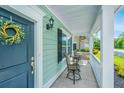 Inviting front porch with outdoor seating, complemented by a welcoming wreath on the front door at 3941 Bessemer Rd, Mount Pleasant, SC 29466