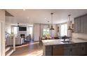 Bright, open-concept living area and kitchen featuring hardwood floors and a fireplace, perfect for entertaining at 401 Oak Hammock Ct # 48, Johns Island, SC 29455