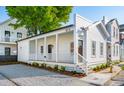 Beautiful home with white siding, a covered porch, an open layout, and fresh landscaping, offering outdoor charm at 42 Poinsett St, Charleston, SC 29403