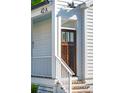 Close-up of the front door with white railing, showcasing the detail of the entryway, creating inviting welcome at 42 Poinsett St, Charleston, SC 29403