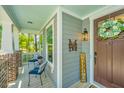 Inviting front porch with seating, a wreath on the door, and a welcome sign at 474 Woodspring Rd, Mount Pleasant, SC 29466