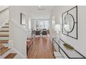 Bright entryway with wood floors, an elegant mirror, and a view into the living room at 488 Queenview Ln, Charleston, SC 29414