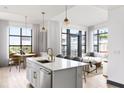Open concept kitchen features a large island, stainless appliances, and seamless flow to the living area at 5 Gadsdenboro St # 503, Charleston, SC 29401