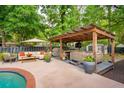 Inviting outdoor space features a covered pergola with lounge area, grill, and hot tub at 5 S Basilica Ave, Hanahan, SC 29410
