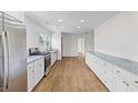 Bright kitchen with white cabinets, stainless appliances, and hardwood floors at 5163 W Dolphin St, North Charleston, SC 29405