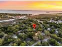 An aerial view of a home nestled amongst lush trees near a scenic body of water at 521 Pelzer Dr, Mount Pleasant, SC 29464
