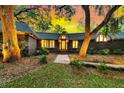 Charming brick home with a stone walkway leading to the entrance framed by mature trees at 521 Pelzer Dr, Mount Pleasant, SC 29464