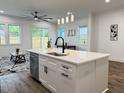 Contemporary kitchen island with stainless steel dishwasher and black water faucet at 5841 Kirkwood Ave, North Charleston, SC 29406