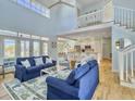 Spacious living room boasts high ceilings, hardwood floors, and access to an open-concept kitchen at 6 Intracoastal Ct, Isle of Palms, SC 29451