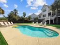 Enjoy the outdoors with this private pool surrounded by lounge chairs and manicured landscape at 6 Intracoastal Ct, Isle of Palms, SC 29451