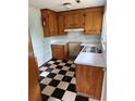 Classic kitchen featuring ample cabinetry, white countertops, and a checkered floor, ready for your personal touch at 609 Coral St, Mount Pleasant, SC 29464