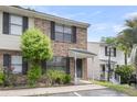 Brick townhome with black shutters, and a well-manicured lawn at 6260 Brandt St # 4-D, North Charleston, SC 29406