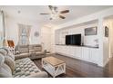 Cozy living room with hardwood floors, comfortable seating, a ceiling fan, and built in entertainment center at 632 Grassy Hill Rd, Summerville, SC 29483
