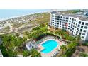 Aerial view of a beachfront condo complex featuring a pool, lounge chairs, and beach access at 8000 Palmetto Dr # 104-A, Isle of Palms, SC 29451