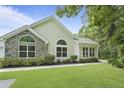 Charming one-story house featuring large windows and a well-maintained lawn, creating a welcoming atmosphere at 8800 Dorchester Rd # 4001, North Charleston, SC 29420