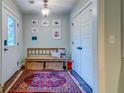 Cozy entryway featuring a wooden bench, decorative rug, and ample closet space at 902 Mikell Dr, Charleston, SC 29412