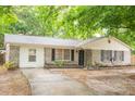 Welcoming home showcasing a manicured lawn, brick facade, and inviting front entrance at 9887 Midview Dr, Ladson, SC 29456
