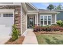 Charming entrance with stone accents and lush landscaping welcomes visitors to this beautifully maintained home at 1011 Old Field Dr, Summerville, SC 29483