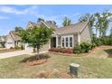 Inviting home exterior with a manicured lawn, blooming flower beds, and a tree, creating curb appeal at 1011 Old Field Dr, Summerville, SC 29483