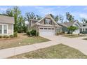 View of a well-maintained home with a two-car garage, showcasing the neatly kept lawn and neighborhood setting at 1011 Old Field Dr, Summerville, SC 29483