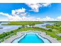 Stunning aerial view of community pool with lounge chairs and water views at 105 Tidewater Way, Charleston, SC 29492