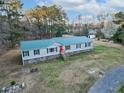 Beautiful home with a green metal roof and a red front door at 107 Bessie Ln, Bonneau, SC 29431