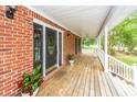 Inviting front porch with ample space, decorative plants, and a ceiling fan for outdoor comfort at 1100 Cass Dr, Moncks Corner, SC 29461