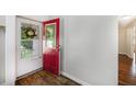 Bright entryway features a decorative red front door with glass panel and wood-look flooring at 115 Myers Rd, Summerville, SC 29486