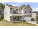 Attractive two-story home with a stone-accented front, covered porch, and well-maintained lawn at 118 Beacon Falls Ct, Summerville, SC 29486
